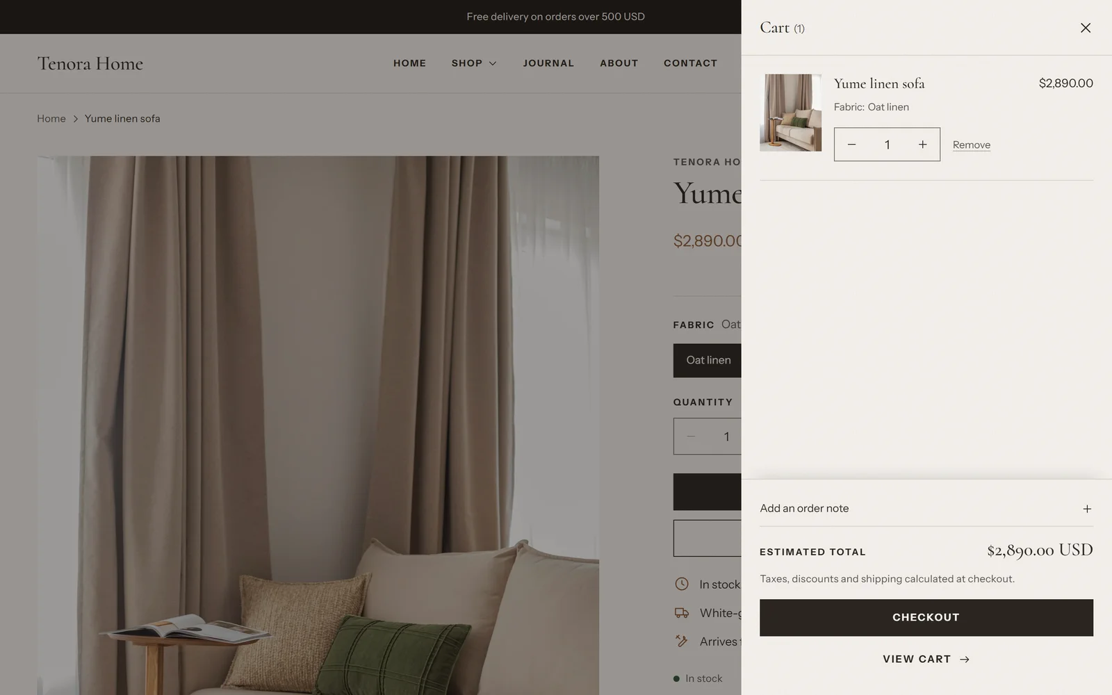 The cart drawer open next to a product page, showing a linen sofa, the quantity selector, the order note, the estimated total and the checkout button